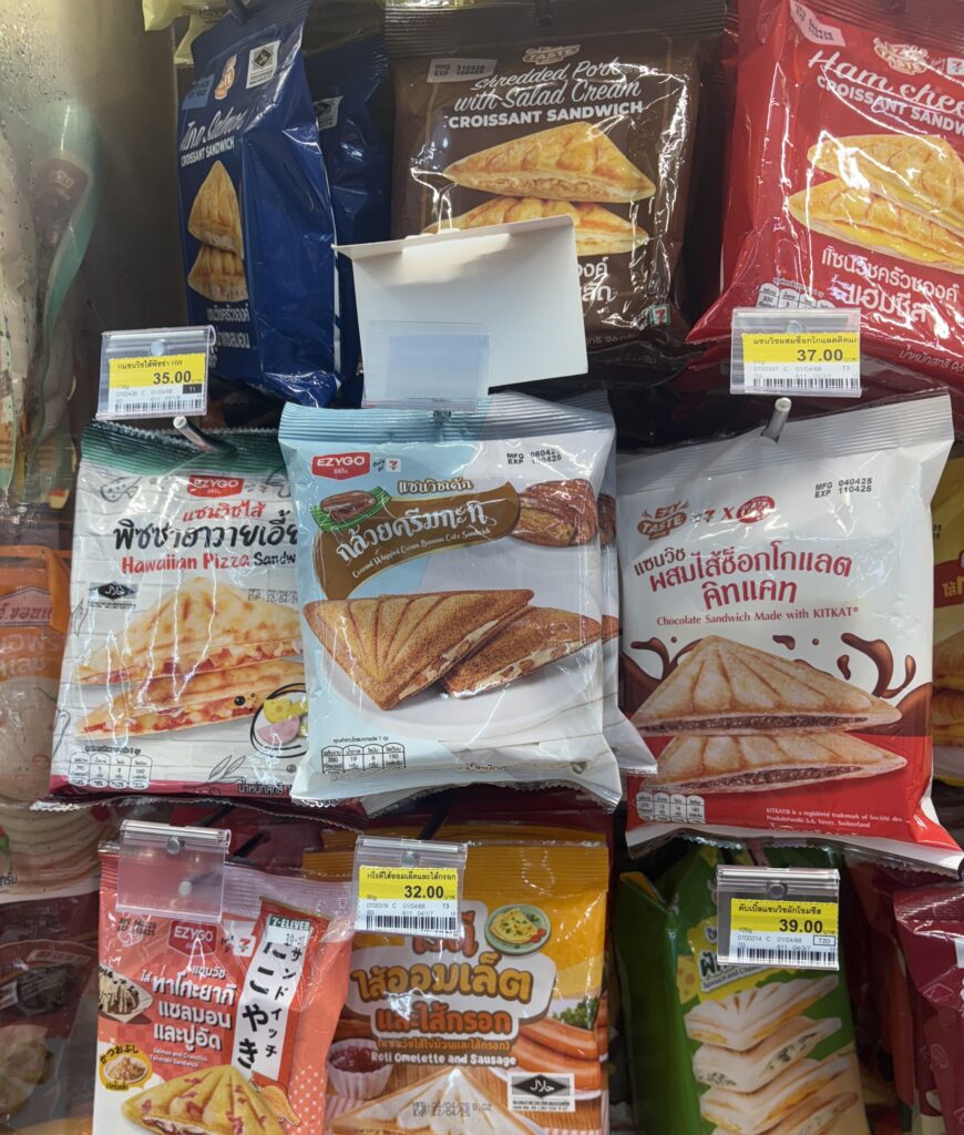 Seven varieties of 7‑Eleven toasties displayed in a Thailand store refrigerator.