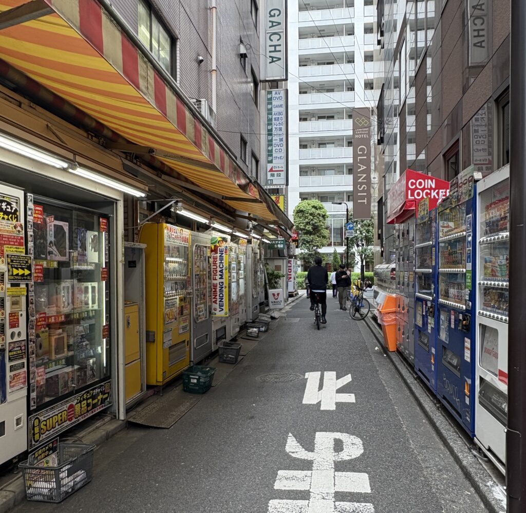 Colorful vending machines lining a narrow alleyway in Tokyo, Japan.
