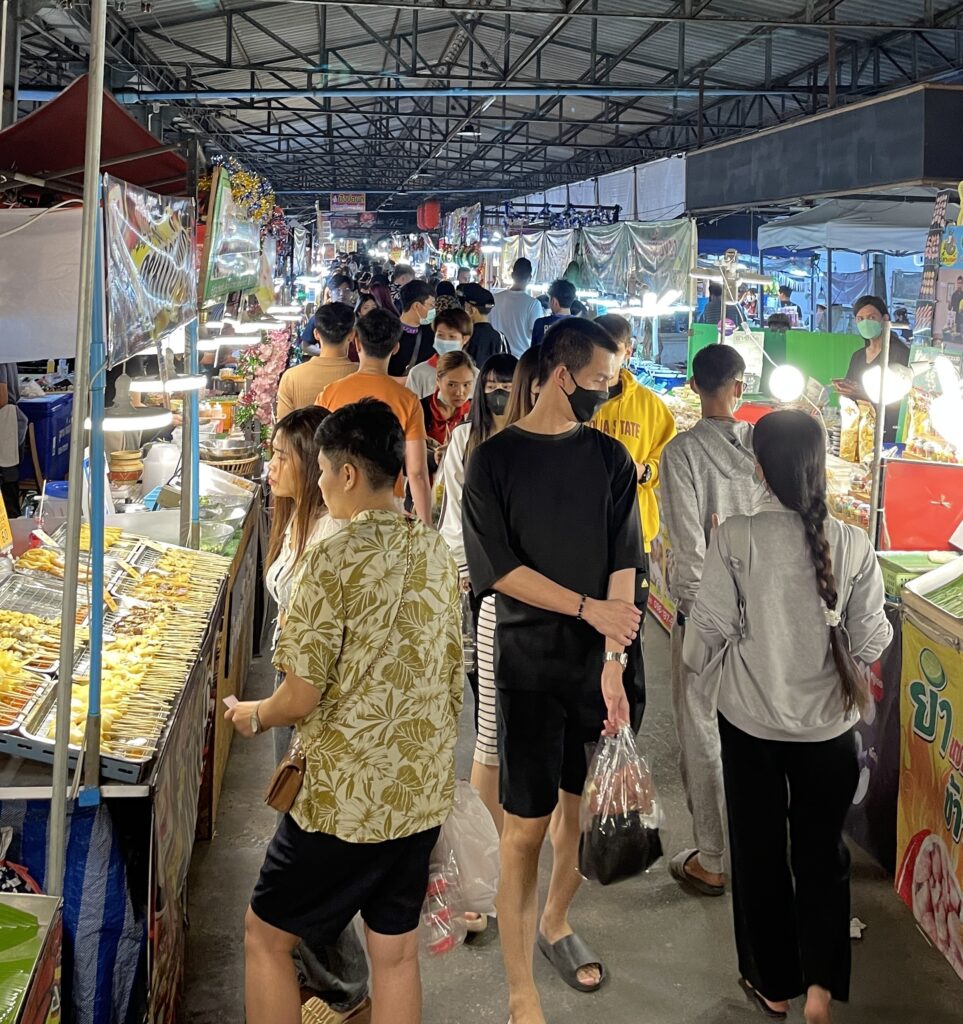 Locals ordering food at stalls in Bangkok’s Train Night Market