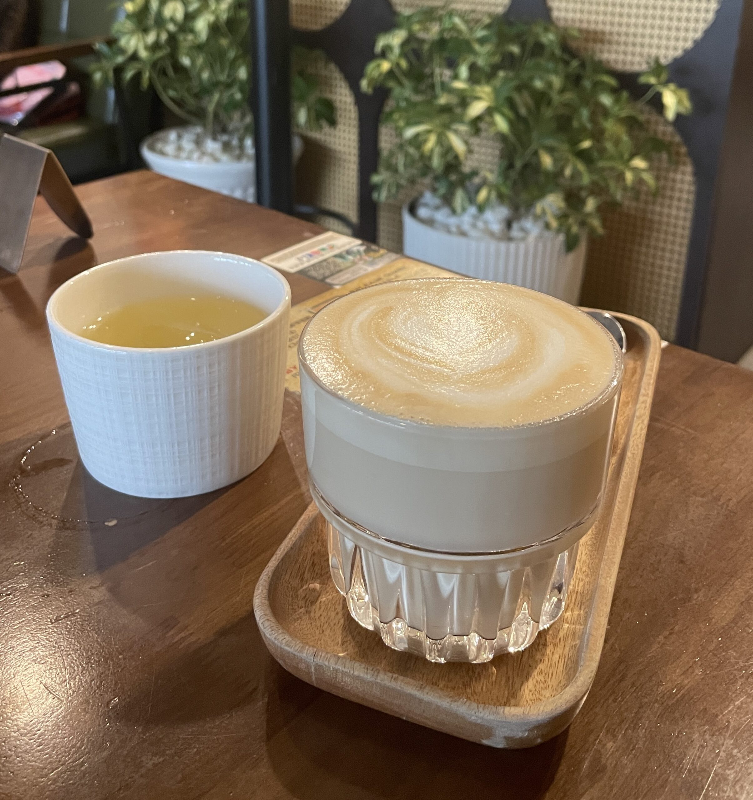 Hot Vietnamese coffee with condensed milk and latte art served on a tray in Saigon
