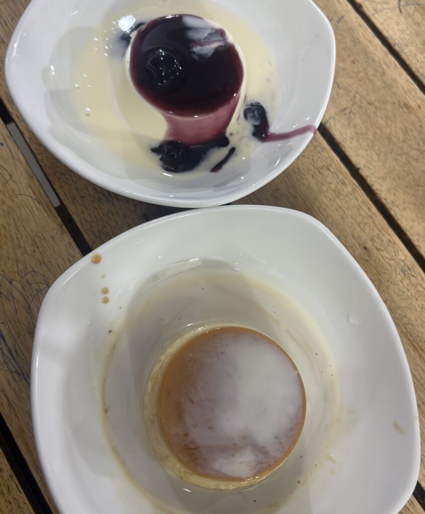 Two servings of bánh flan in Saigon, one classic original flavor and the other topped with blueberry.