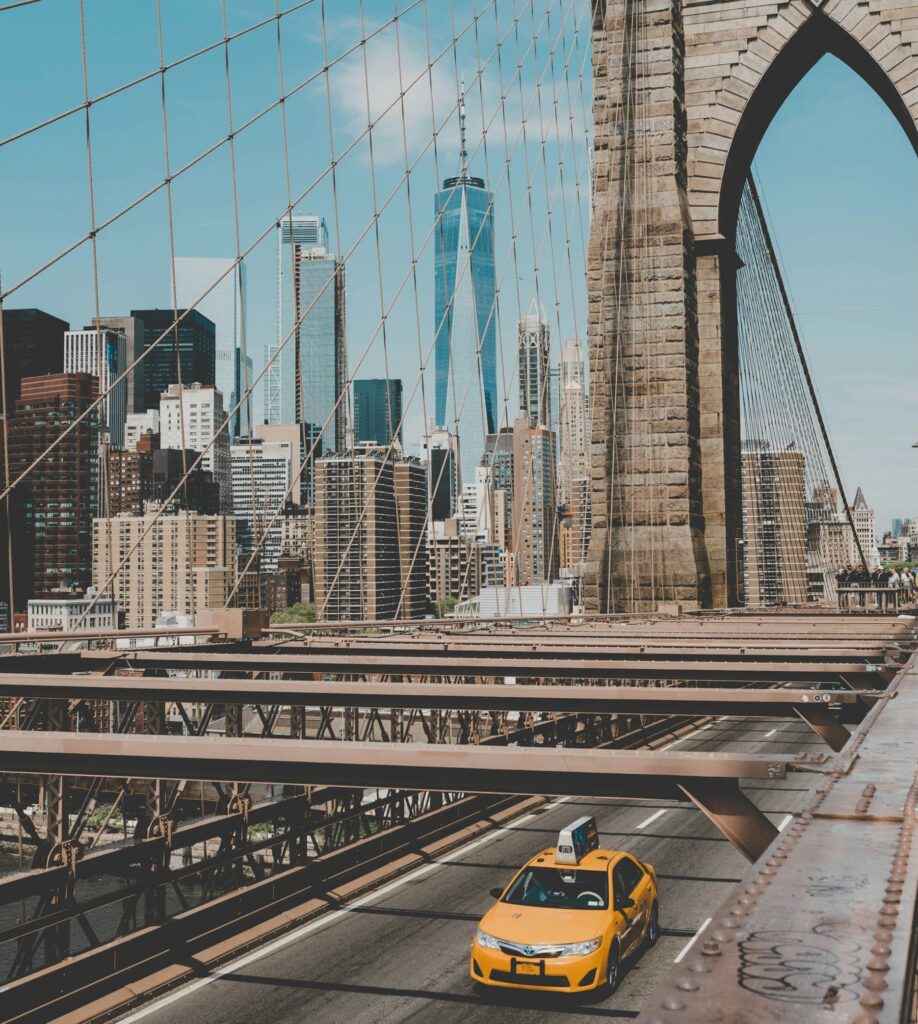 New York City yellow taxi driving across the Brooklyn Bridge