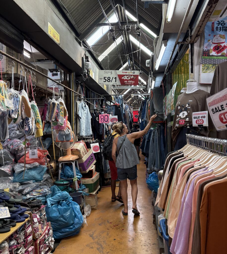 Trendy clothing on display at Bangkok’s Chatuchak Weekend Market, showcasing fashionable styles popular with both locals and tourists.
