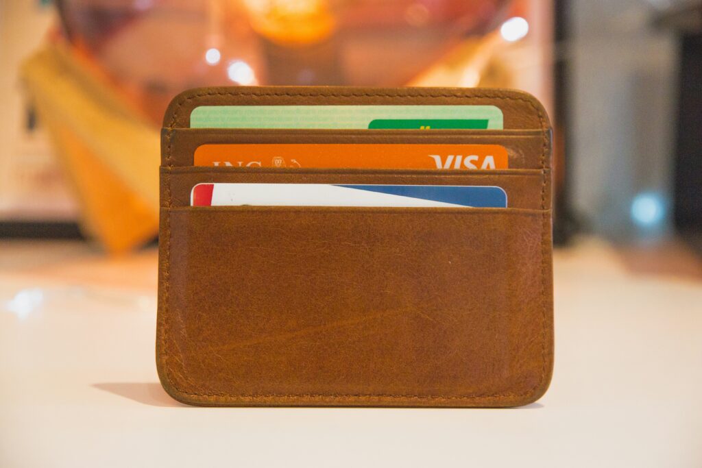 Credit cards stored in a brown leather travel card holder