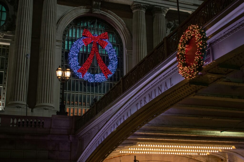 Grand Central sign with lit-up candy cane decoration in New York City.
