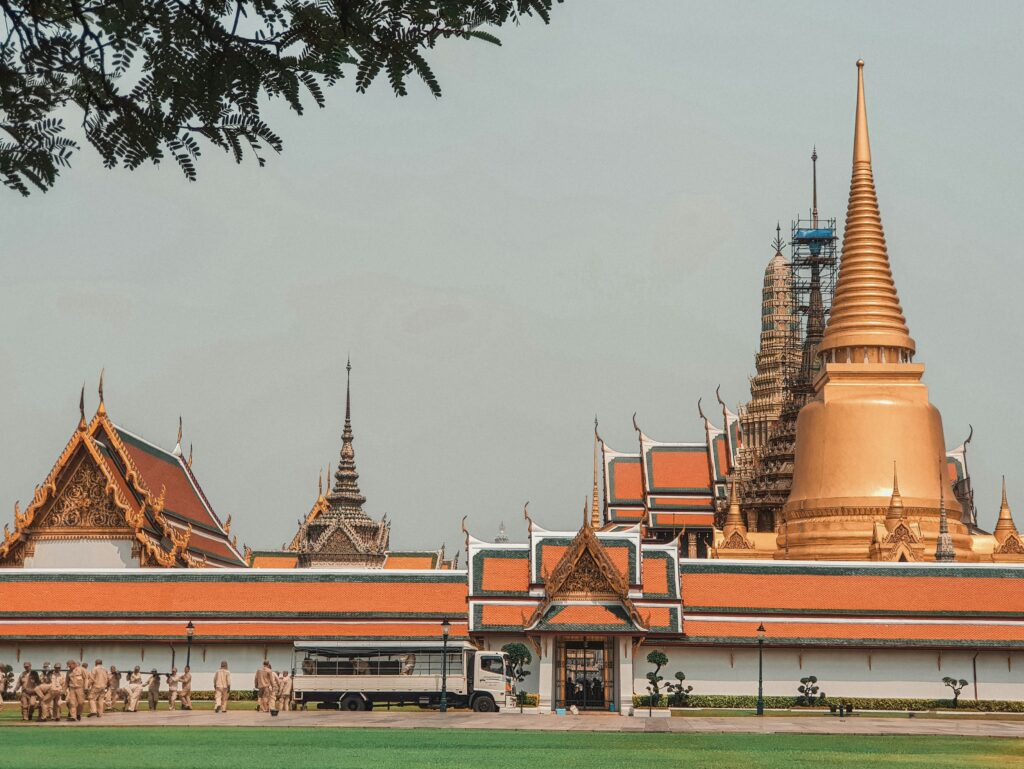 Exterior view of the Grand Palace wall and golden rooftops in Bangkok, Thailand