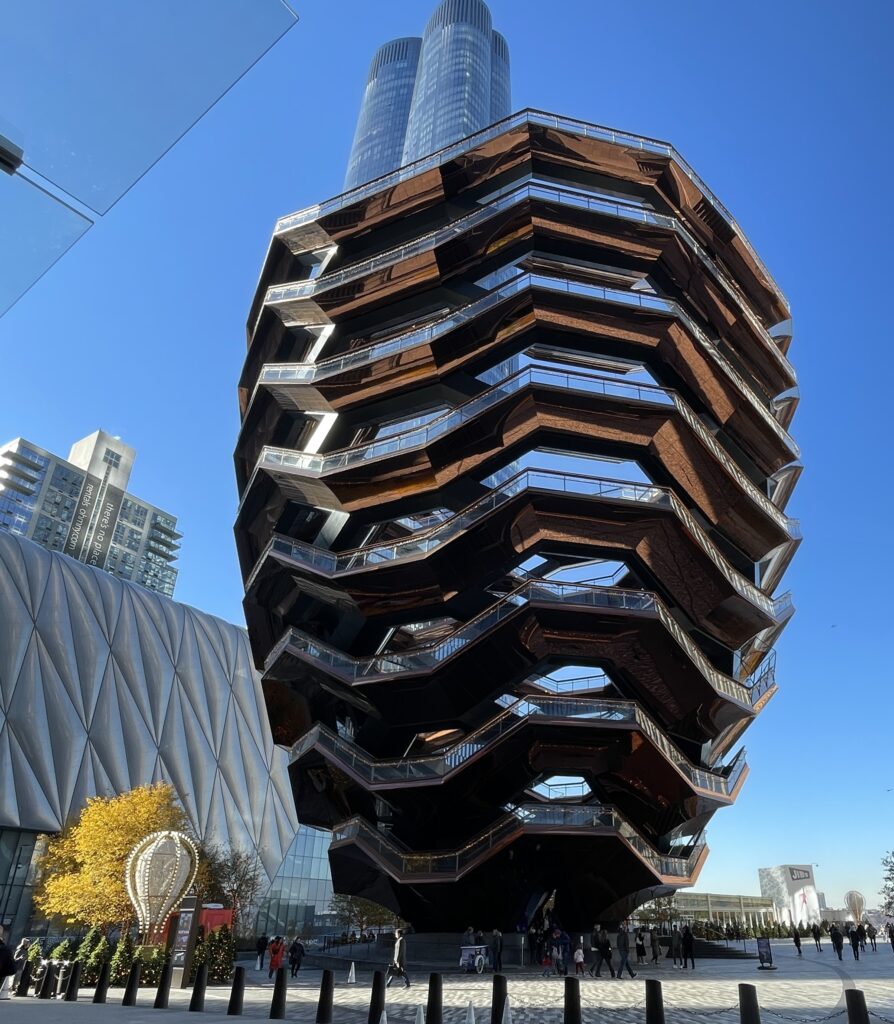View of Hudson Yards in New York City with the famous Vessel building and modern architecture.