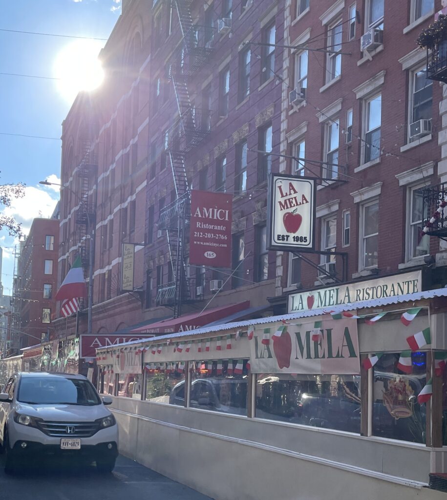 Row of iconic restaurants in Little Italy, New York City, on a sunny winter afternoon.