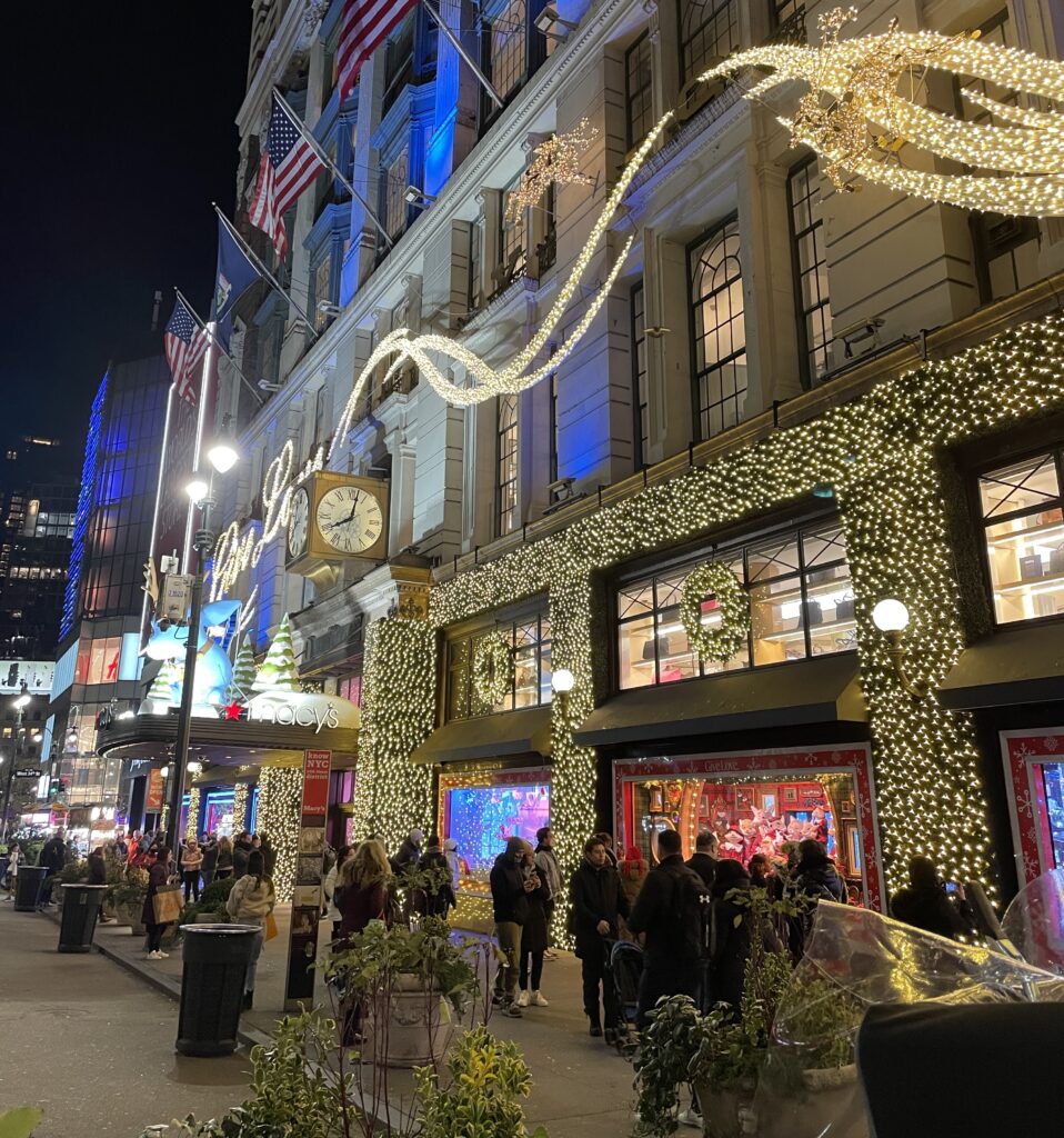 Macy’s department store in New York City lit up with Christmas lights in the evening.