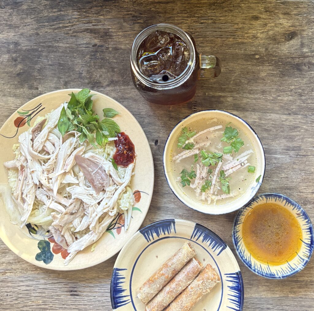 Shredded chicken rice dish recognized by Michelin, served with appetizers at Bep Nguoi Hoi An – Tiem Mi Quang & Com Ga in Saigon.