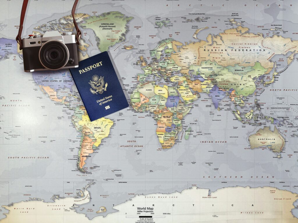 US passport with camera and world map in the background