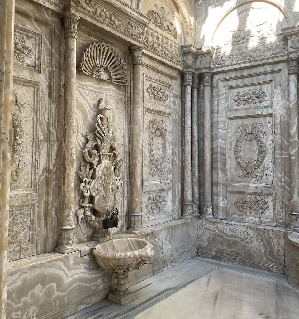 Stunning old marble bath inside Dolmabahce Palace in Istanbul, showcasing elegant Ottoman-era architecture.