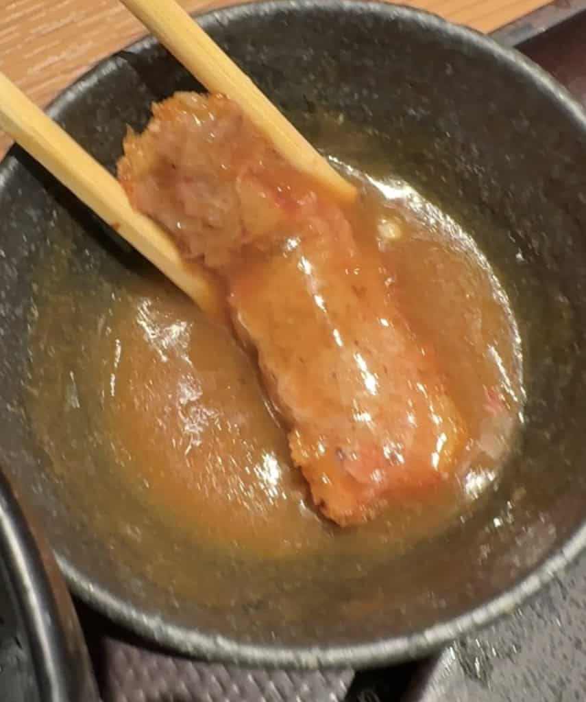 Crispy beef gyukatsu dipped into a thick, flavorful Japanese curry sauce.
