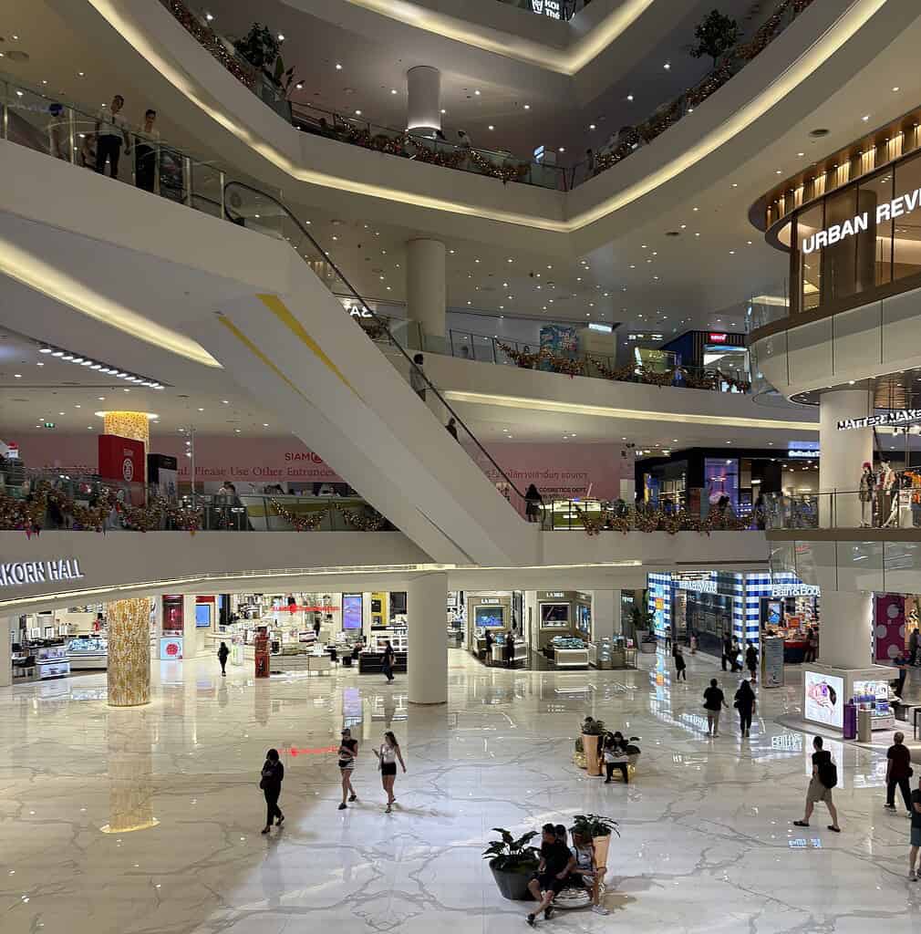 Interior view of IconSiam mall in Bangkok with people walking and striking modern architecture.