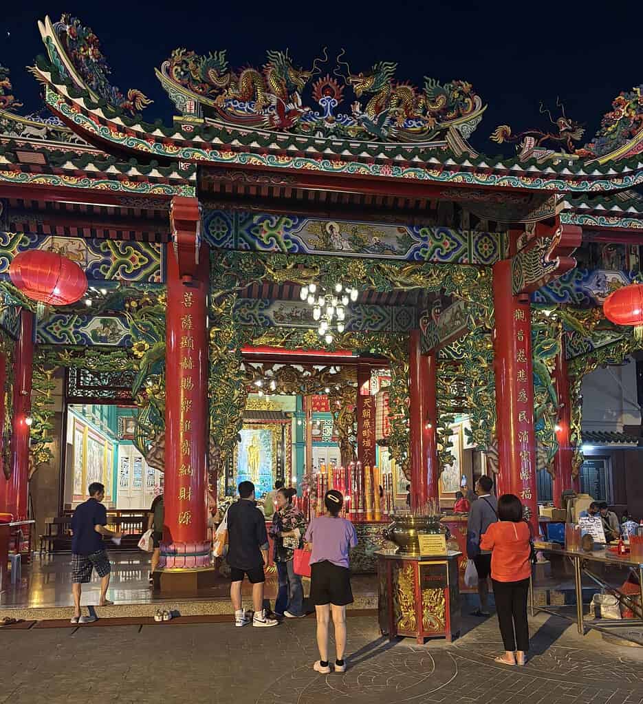 Local Thai worshippers praying at a beautiful temple near Chinatown in Bangkok, Thailand.
