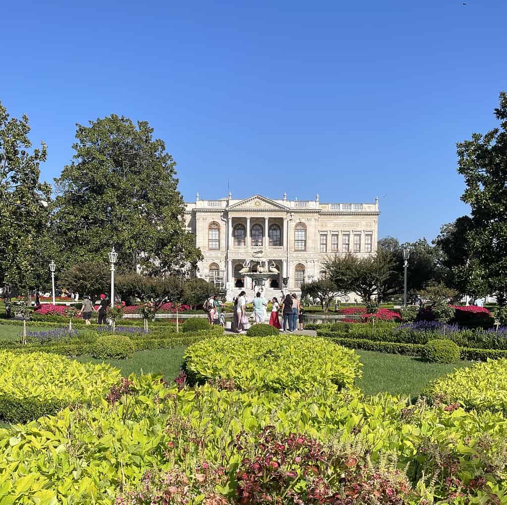Springtime at Dolmabahce Palace in Istanbul with blooming flowers and beautiful palace architecture in the background.