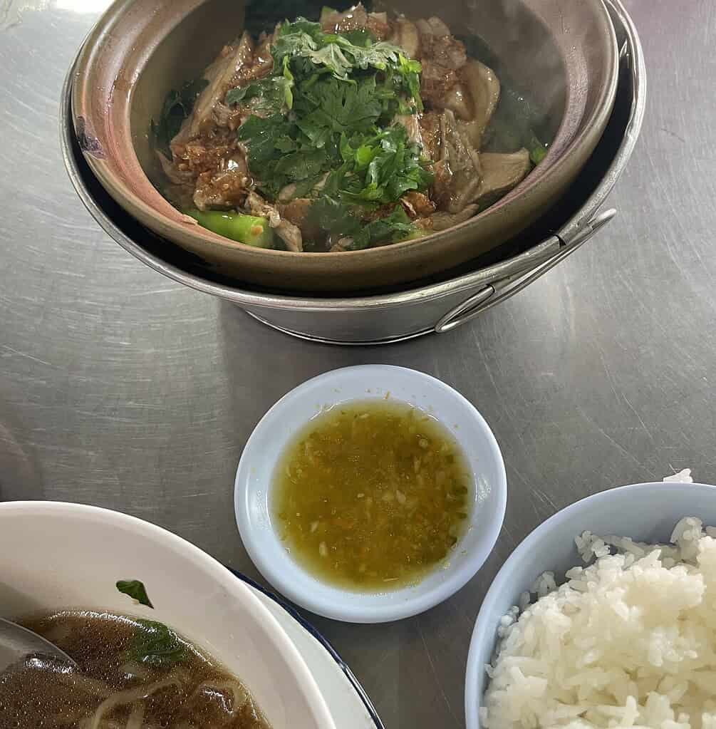 Various duck dishes including claypot, soup, and rice served on a table at Tang Sui Heng Michelin-starred restaurant in Bangkok.